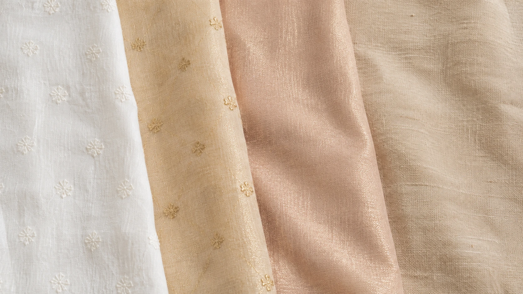 White cotton, gold chanderi, blush tissue and oatmeal linen unstitched suit fabrics laid side by side